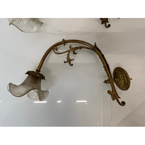 166 - Decorative lighting, a pair of gilded cast brass wall lights, wall to shade length 16 inches overall... 