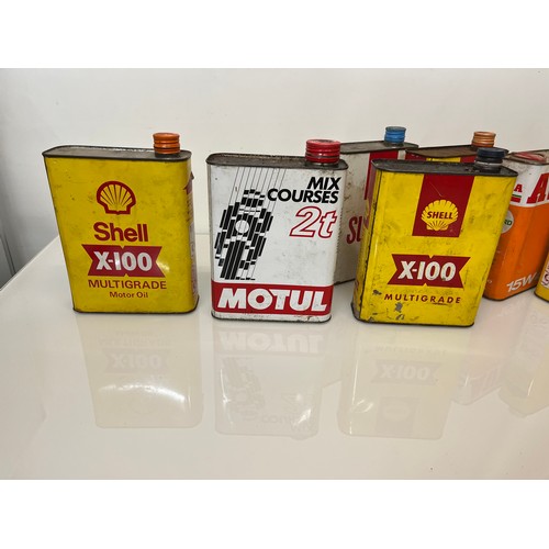 176 - Collection of seven motoring oil cans, shell and other brands.

This lot is available for in-house s... 