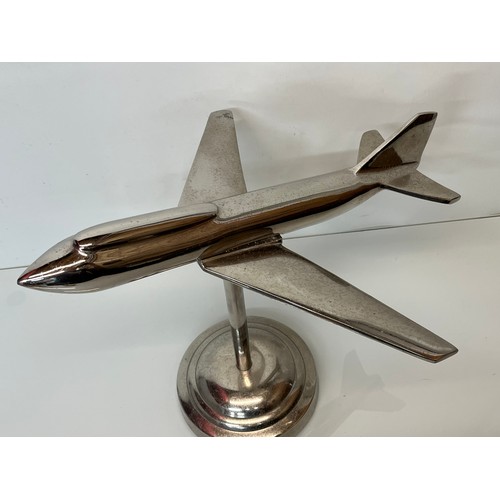 179 - A stylised chrome plated aviation desk piece, a large jet age model of plane with a raised cockpit s... 