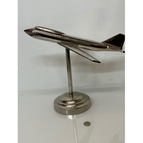 179 - A stylised chrome plated aviation desk piece, a large jet age model of plane with a raised cockpit s... 