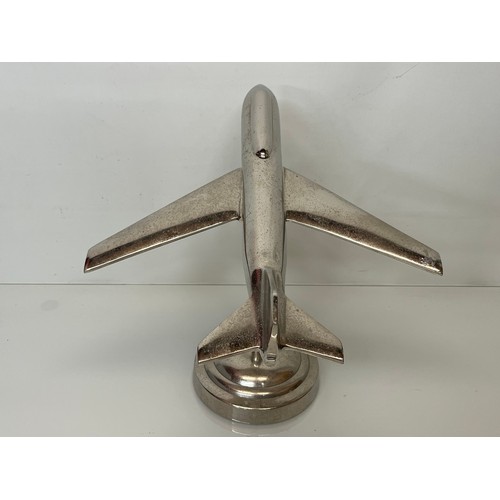 179 - A stylised chrome plated aviation desk piece, a large jet age model of plane with a raised cockpit s... 