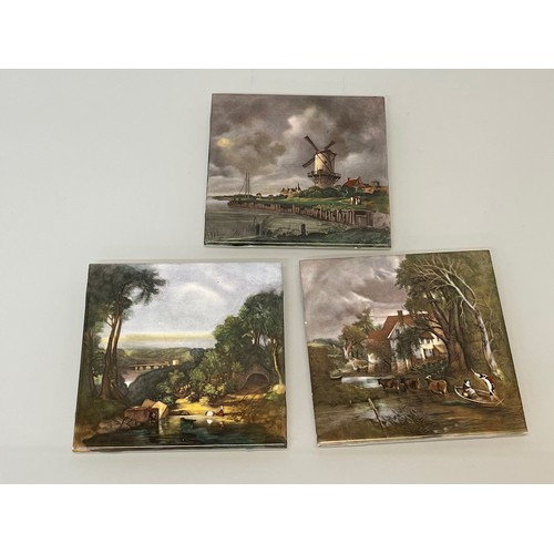 390 - Three decorative tiles decorated with classical country scenes.

In-house shipping is available on t... 