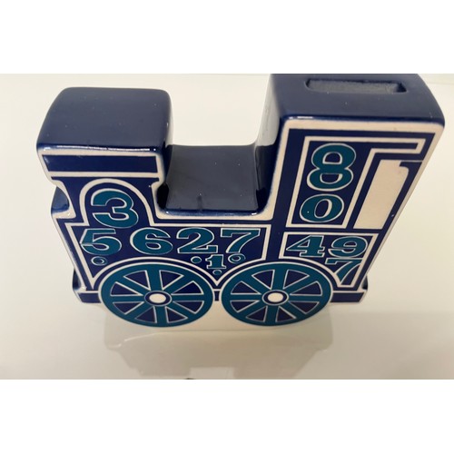 9 - Carlton ware studio pottery money box in the form of a train. 13 cm high x 15 cm long.

This lot is ... 