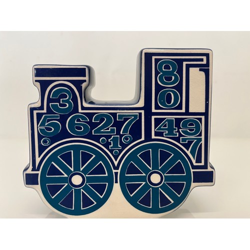 9 - Carlton ware studio pottery money box in the form of a train. 13 cm high x 15 cm long.

This lot is ... 