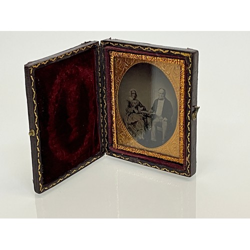 28 - Victorian Daguerreotype photograph of a couple in an gilded oval frame within an velvet lined and em... 