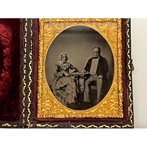 28 - Victorian Daguerreotype photograph of a couple in an gilded oval frame within an velvet lined and em... 