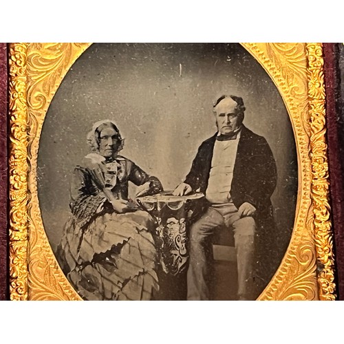 28 - Victorian Daguerreotype photograph of a couple in an gilded oval frame within an velvet lined and em... 