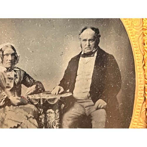 28 - Victorian Daguerreotype photograph of a couple in an gilded oval frame within an velvet lined and em... 