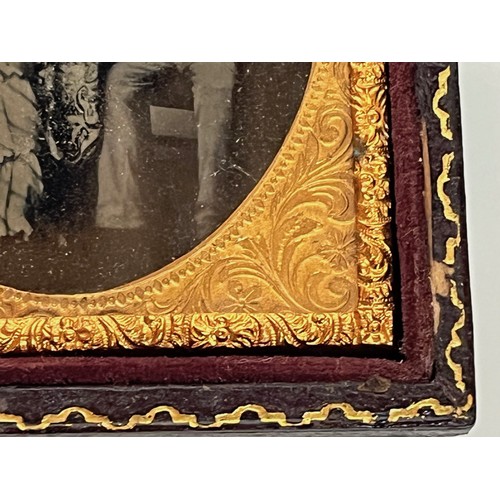 28 - Victorian Daguerreotype photograph of a couple in an gilded oval frame within an velvet lined and em... 