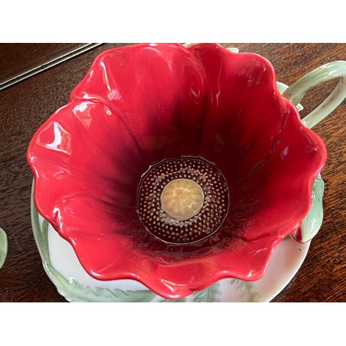 122 - Franz studio ceramics, two flower themed cups and saucers.

This lot is available for in-house shipp... 