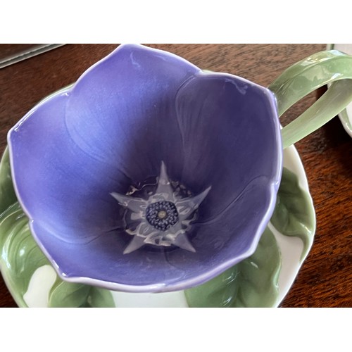 122 - Franz studio ceramics, two flower themed cups and saucers.

This lot is available for in-house shipp... 