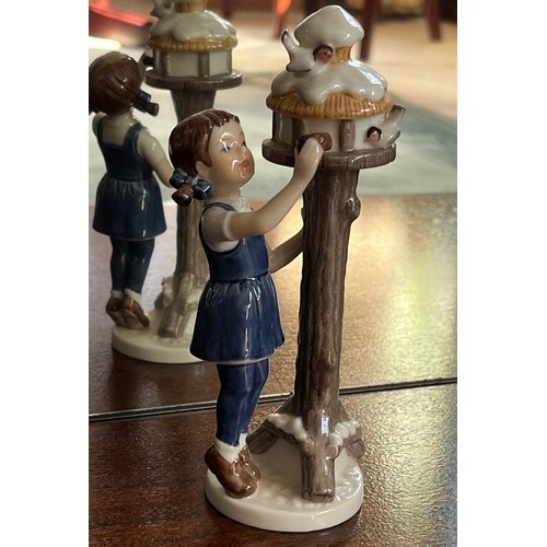 124 - Royal Copenhagen ceramic figure of a girl tending  a bird box.

This lot is available for in-house s... 