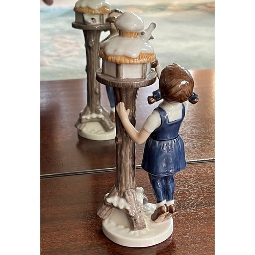 124 - Royal Copenhagen ceramic figure of a girl tending  a bird box.

This lot is available for in-house s... 