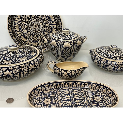 141 - Table ware, indian studio pottery , a collection of hand decorated serving items.

This lot is colle... 