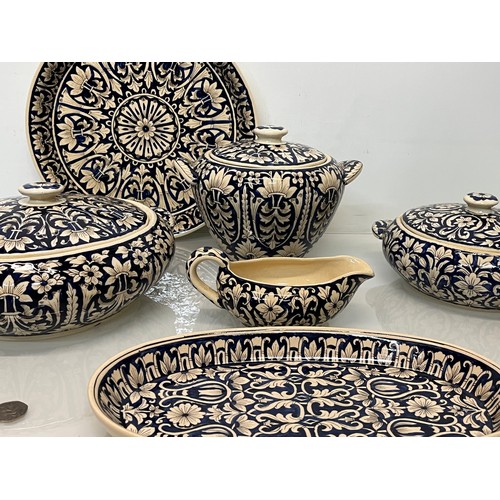 141 - Table ware, indian studio pottery , a collection of hand decorated serving items.

This lot is colle... 