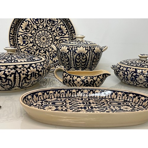 141 - Table ware, indian studio pottery , a collection of hand decorated serving items.

This lot is colle... 