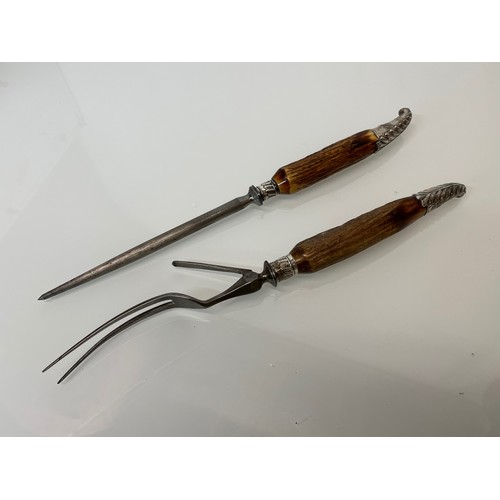 525 - Horn handled carving set with hallmarked silver mounts.

This lot is available for in-house shipping