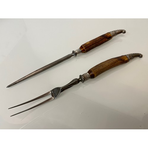 525 - Horn handled carving set with hallmarked silver mounts.

This lot is available for in-house shipping