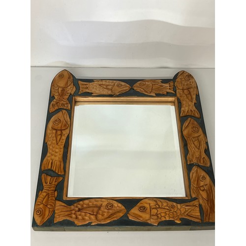 219 - Contempery hand carved wooden framed mirror, decorated with fish. 63 cm x 56 cm x 5 cm.

This lot is... 