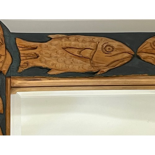 219 - Contempery hand carved wooden framed mirror, decorated with fish. 63 cm x 56 cm x 5 cm.

This lot is... 