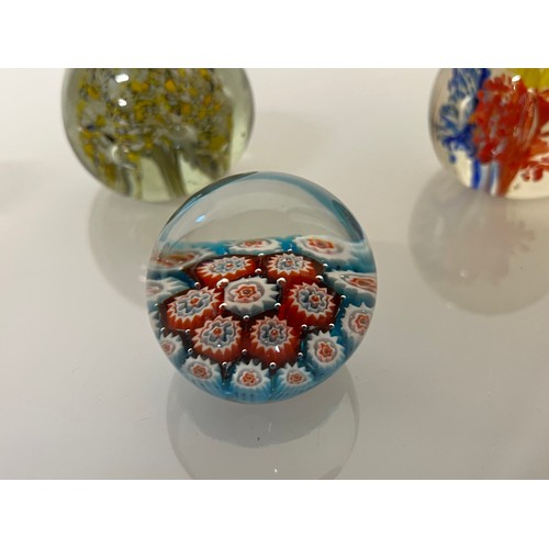 303 - Five decorative glass paper weights.

This lot is available for in-house shipping