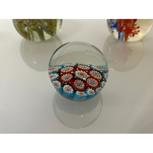 303 - Five decorative glass paper weights.

This lot is available for in-house shipping