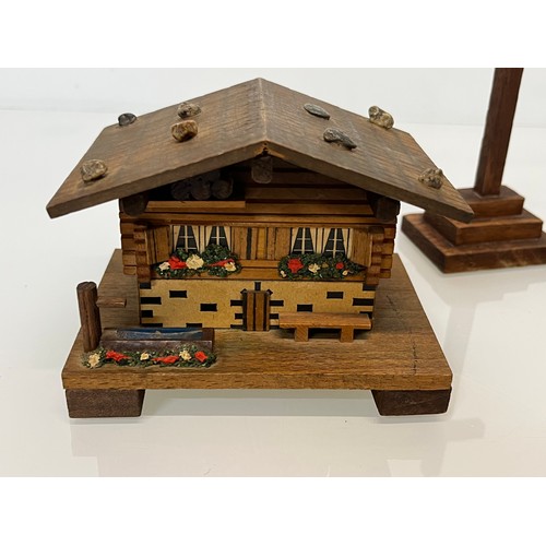 305 - Collection of souvenir treen, a Swiss musical box and barometer, a carved terrier dog pen stand and ... 