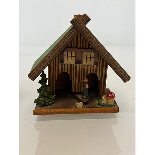 305 - Collection of souvenir treen, a Swiss musical box and barometer, a carved terrier dog pen stand and ... 