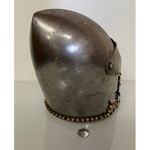 248 - A Medieval design knights helmet with weighted brass trimmings on a steel shell. 26 cm tall x 30 cm ... 