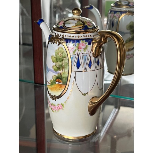 253 - Noritake teapot, gilded decoration and panels with painted landscapes.

This lot is available for in... 