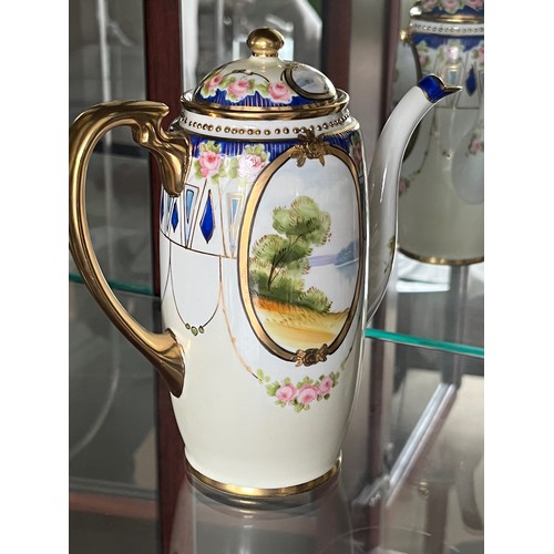 253 - Noritake teapot, gilded decoration and panels with painted landscapes.

This lot is available for in... 