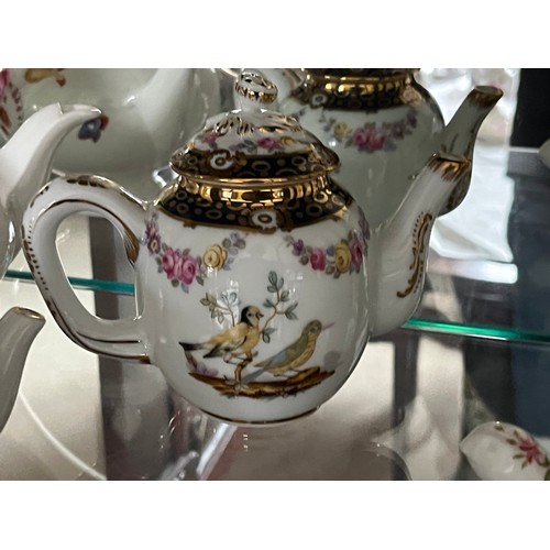 258 - Two teapots from the Victoria and Albert museum range by Franklin Mint and another, a Coalport examp... 