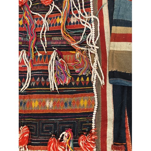 312 - Asian tribal art, an unusual antique jacket from a Hill tribe in Thailand, woven woollen body with d... 