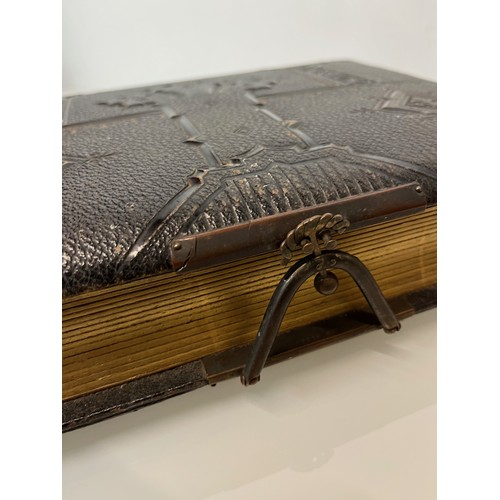 316 - A large early C20th photograph album with pages decorated with botanical illustrations throughout.

... 