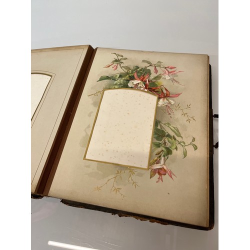 316 - A large early C20th photograph album with pages decorated with botanical illustrations throughout.

... 