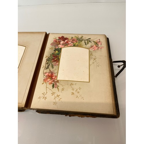 316 - A large early C20th photograph album with pages decorated with botanical illustrations throughout.

... 