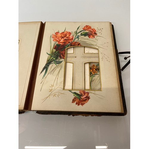 316 - A large early C20th photograph album with pages decorated with botanical illustrations throughout.

... 