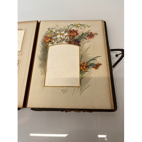 316 - A large early C20th photograph album with pages decorated with botanical illustrations throughout.

... 