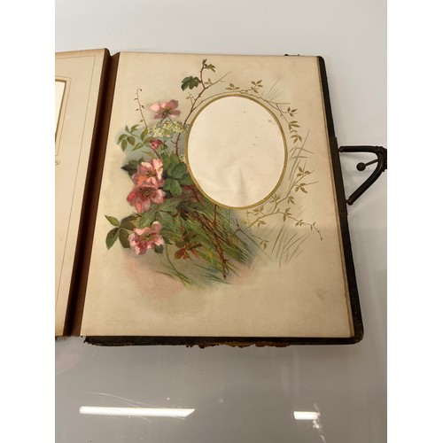 316 - A large early C20th photograph album with pages decorated with botanical illustrations throughout.

... 