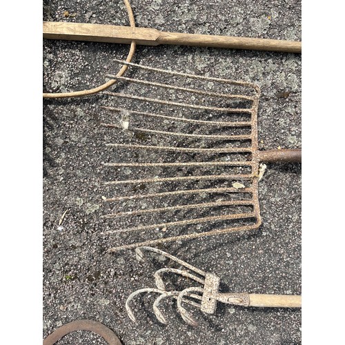 330 - Five vintage hand tools, wooden rake and forks etc.

This lot is collection only