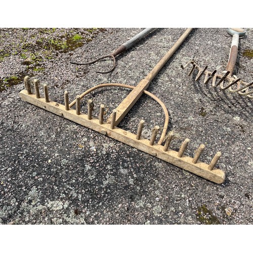 330 - Five vintage hand tools, wooden rake and forks etc.

This lot is collection only