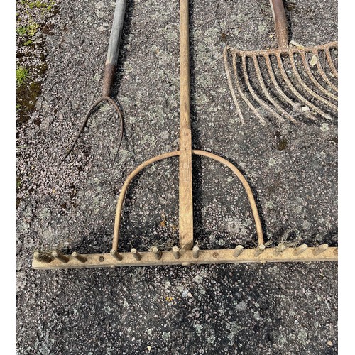 330 - Five vintage hand tools, wooden rake and forks etc.

This lot is collection only