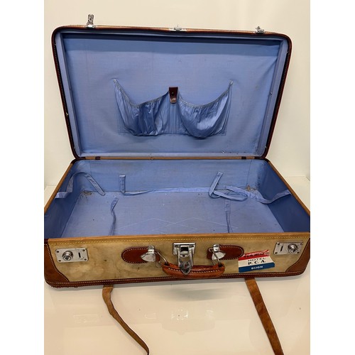 333 - Leather trimmed suitcase, with securing straps and a collection of baggage labels attached. 74 cm x ... 