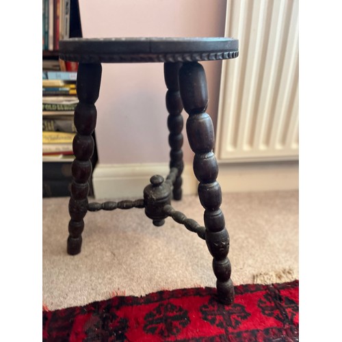 2 - Decorative furniture, a hand carved three legged stool, 32 cm diameter top 48 cm high.

This lot is ... 