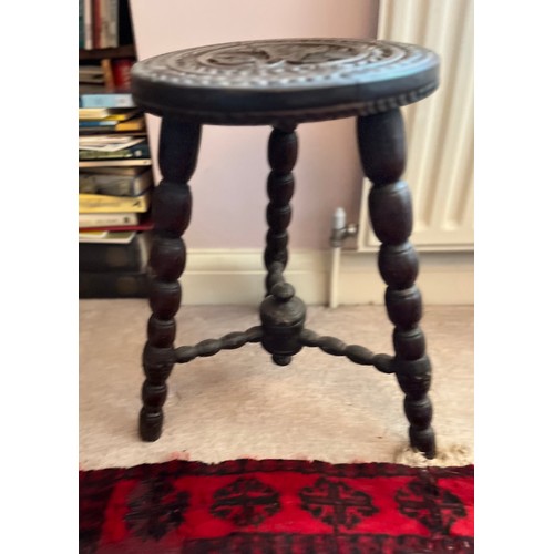 2 - Decorative furniture, a hand carved three legged stool, 32 cm diameter top 48 cm high.

This lot is ... 