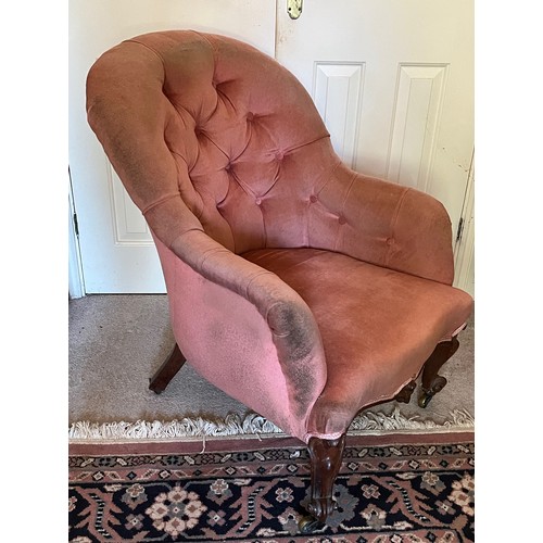 17 - An upholstered Victorian armchair with a tubed back and serpentine front on carved legs, 67 cm wide ... 