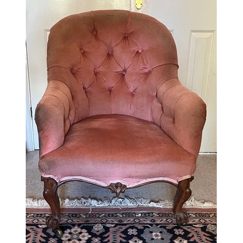 17 - An upholstered Victorian armchair with a tubed back and serpentine front on carved legs, 67 cm wide ... 