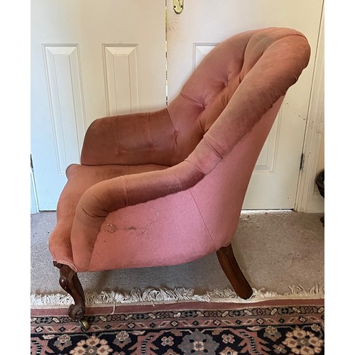 17 - An upholstered Victorian armchair with a tubed back and serpentine front on carved legs, 67 cm wide ... 