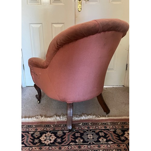 17 - An upholstered Victorian armchair with a tubed back and serpentine front on carved legs, 67 cm wide ... 