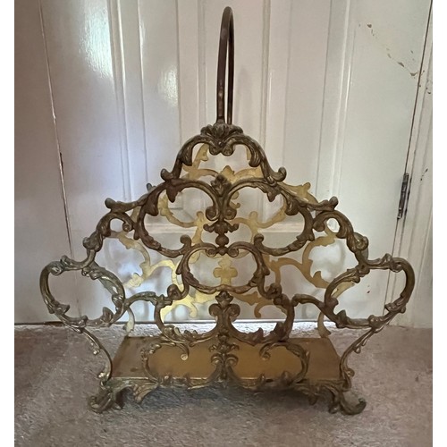 19 - Metal magazine rack with cast brass sides, 44 cm long x 47 cm high.

This lot is collection only